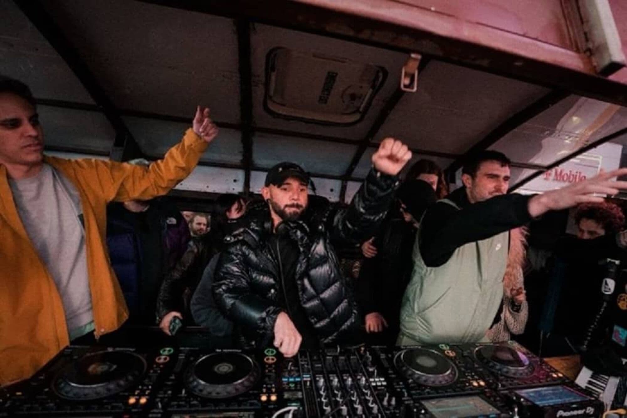 Skrillex, Fred again.., and Four Tet DJing inside the City Soul Bus