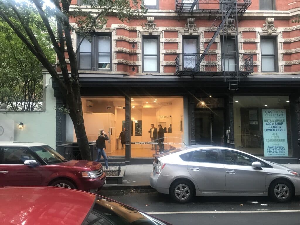 Completed storefront — warm glow visible from the street