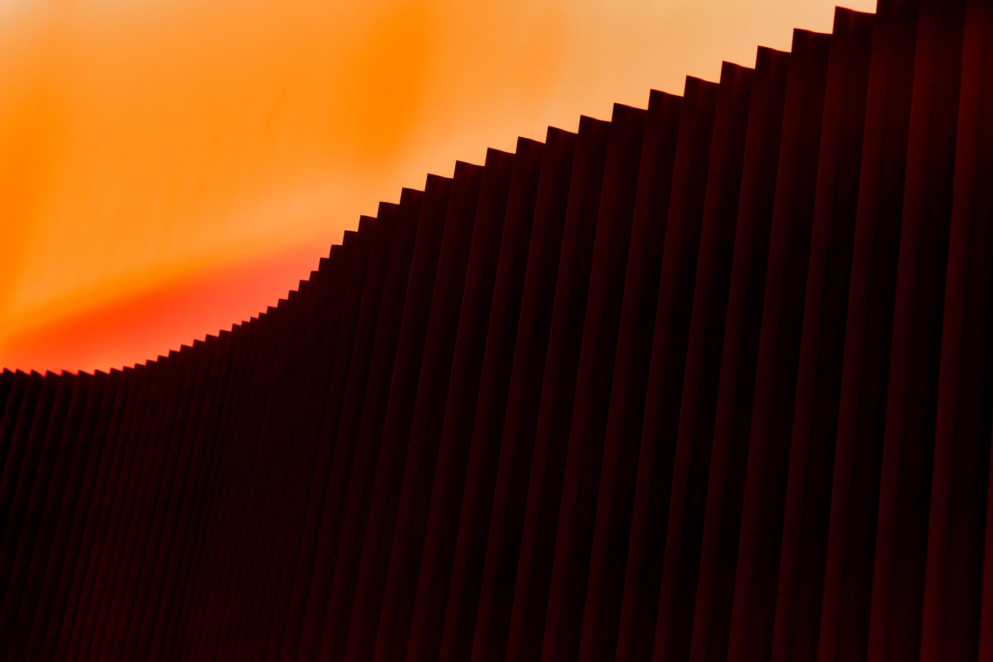 Detail — ribbed wall panels with amber cove light washing overhead