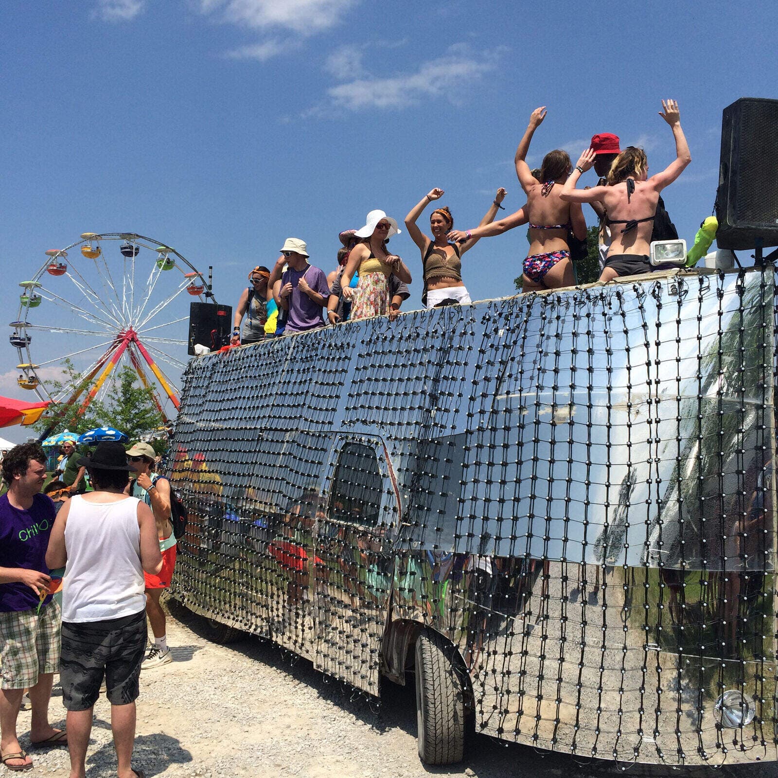 Mirage at Bonnaroo — crowd on the rooftop, ferris wheel in background