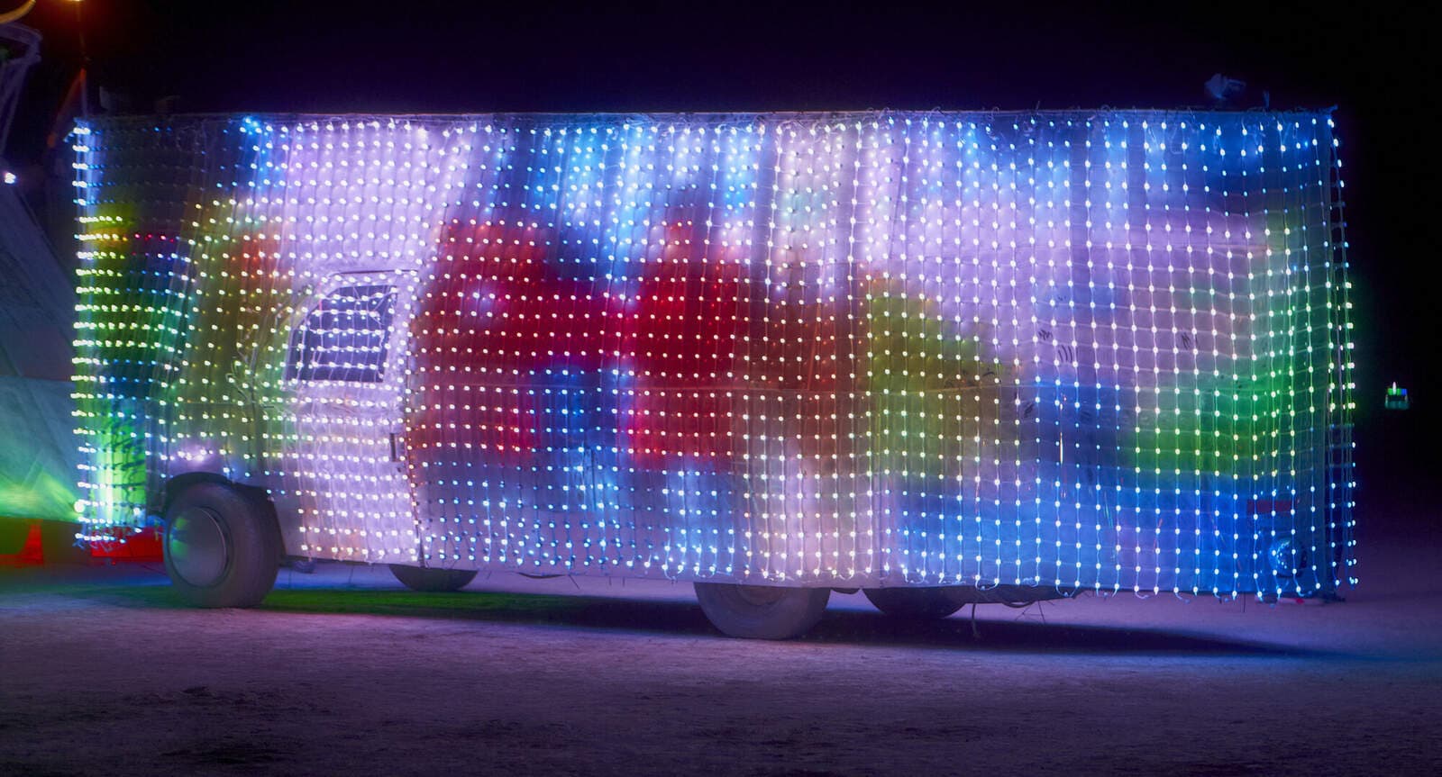 Mirage 2.0 — LED pixel skin displaying generative color content at night
