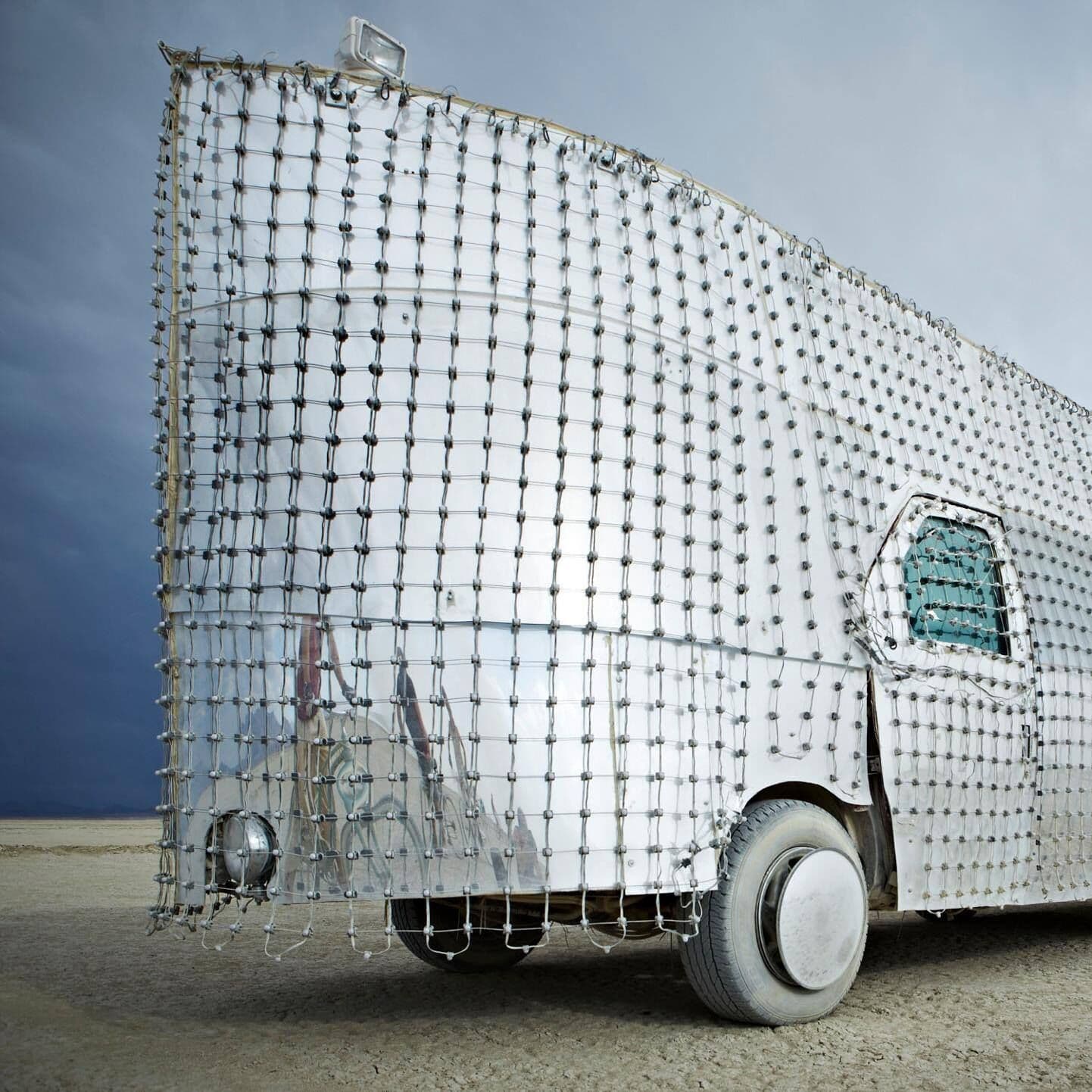 Detail — LED pixel nodes on the mesh grid, mirror surface visible beneath