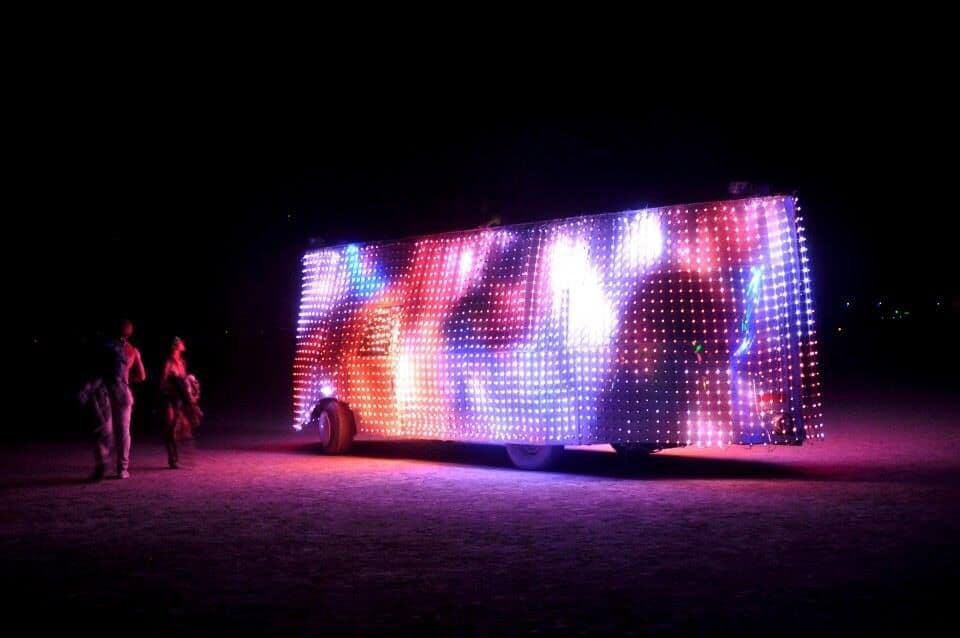 Night — rainbow generative content, people walking past for scale