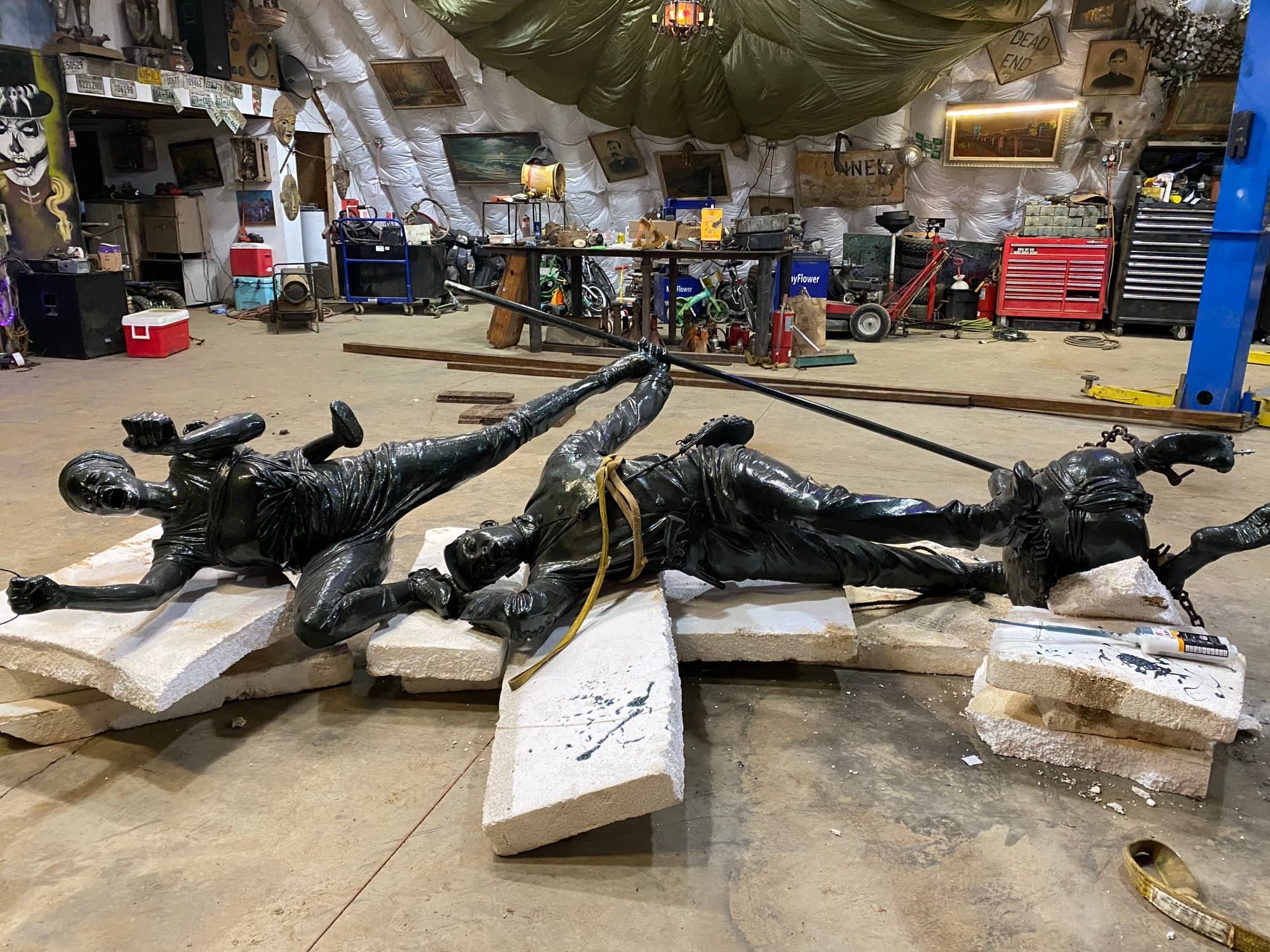 Four figures laid out in the workshop