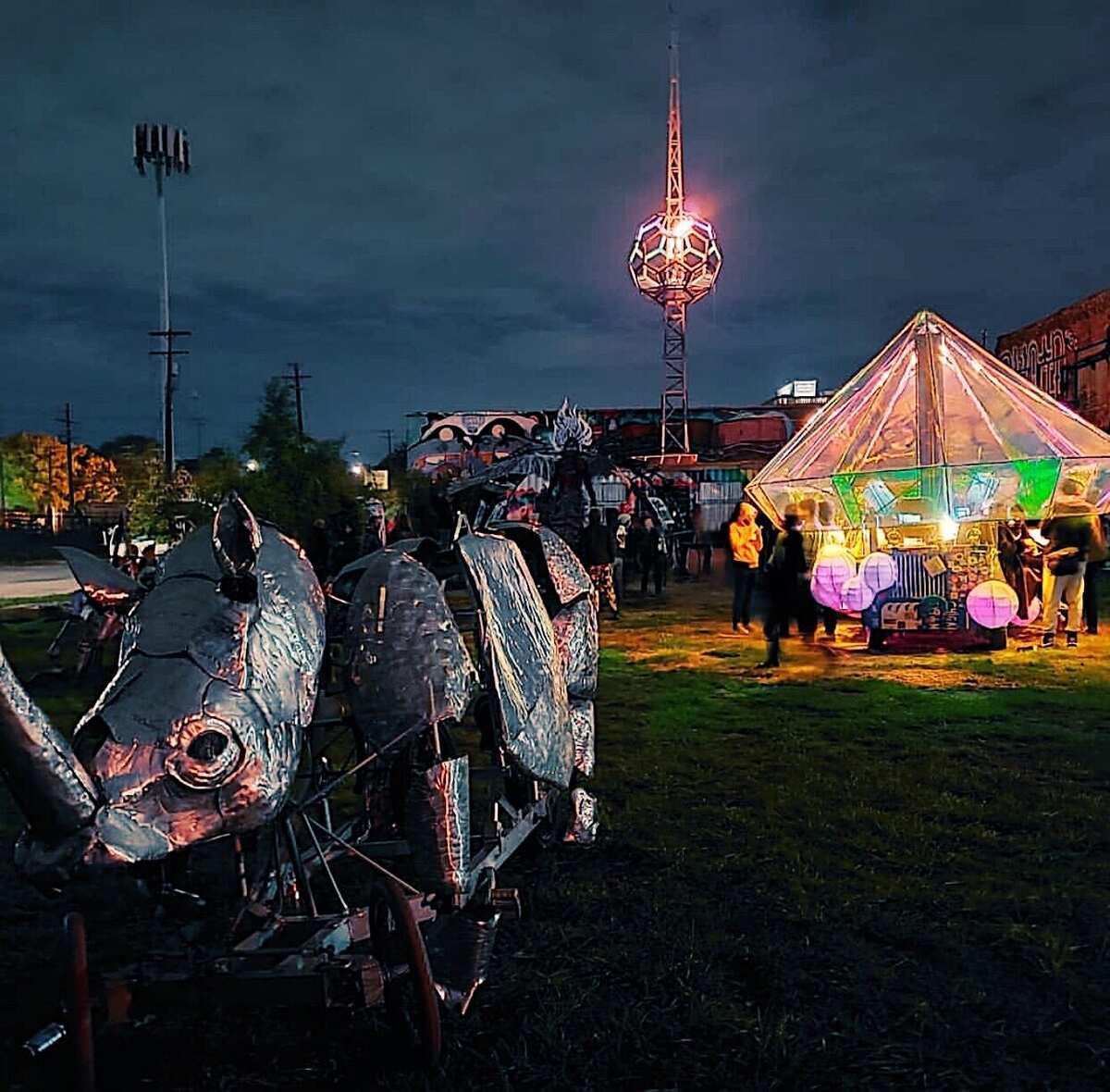 Festival night — beacon glowing above the compound