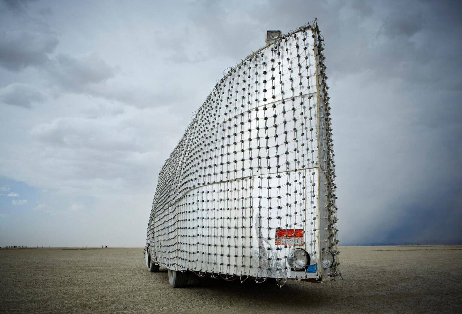 Rear view — mesh structure against dramatic sky