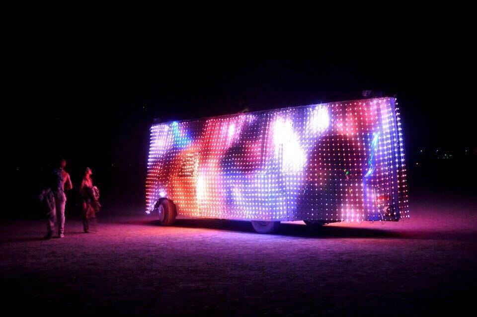 Rainbow generative content, people walking past for scale