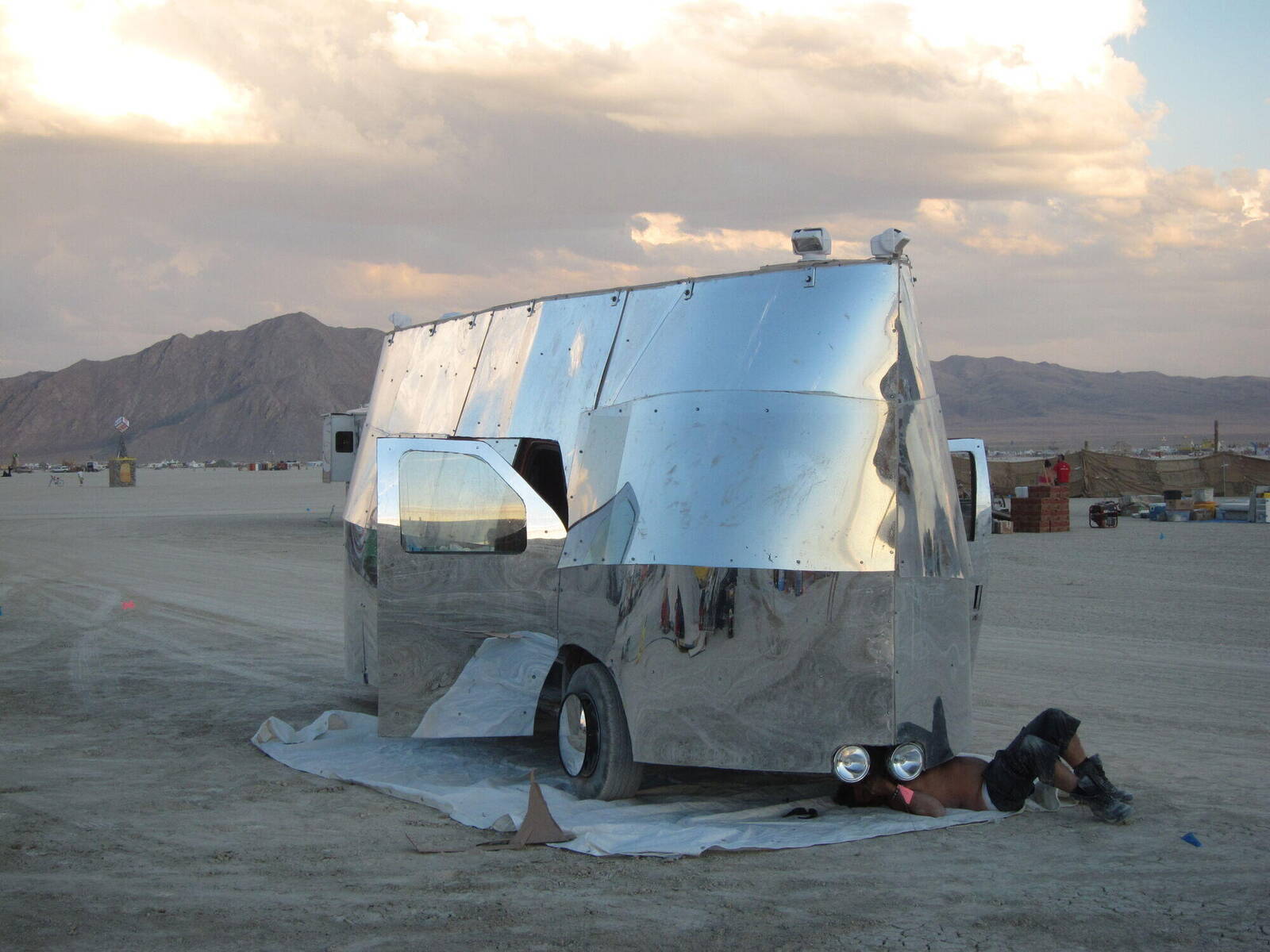 Mirage 1.0 — mirror-clad van on the playa at sunset