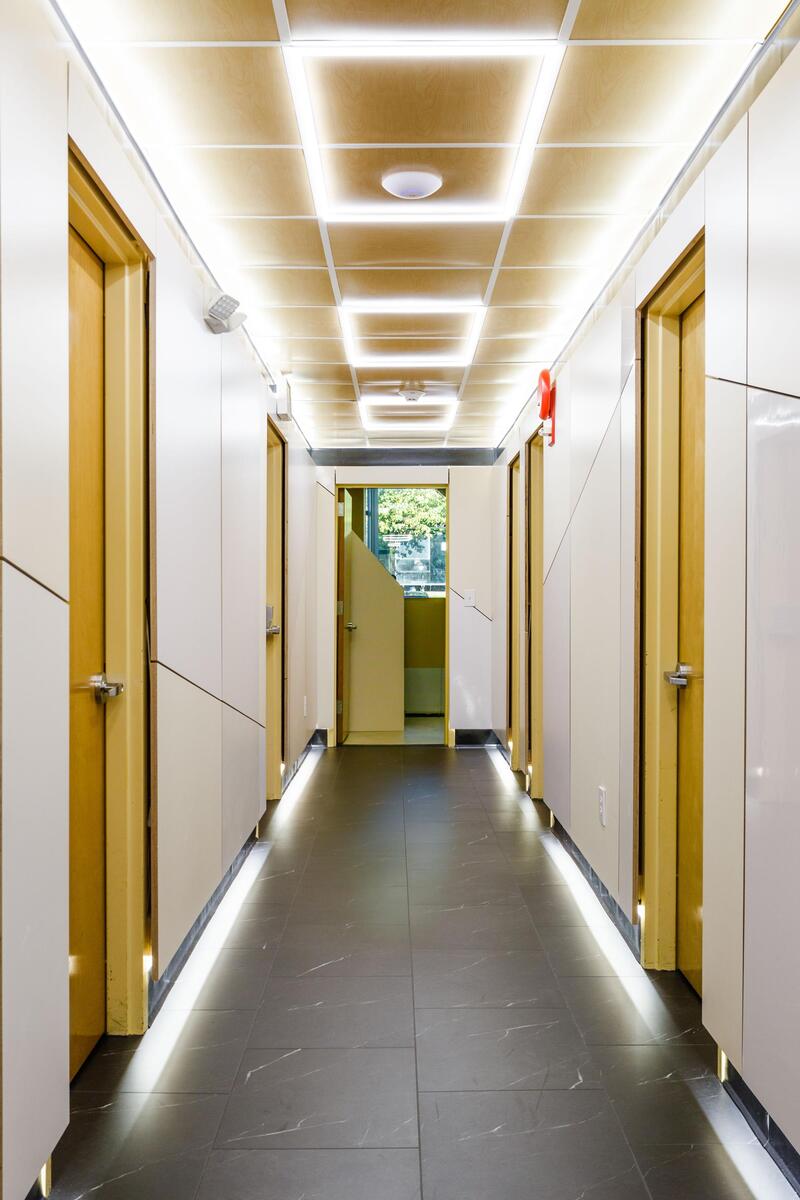 Hallway — LED ceiling grid, base lighting, dark stone floor